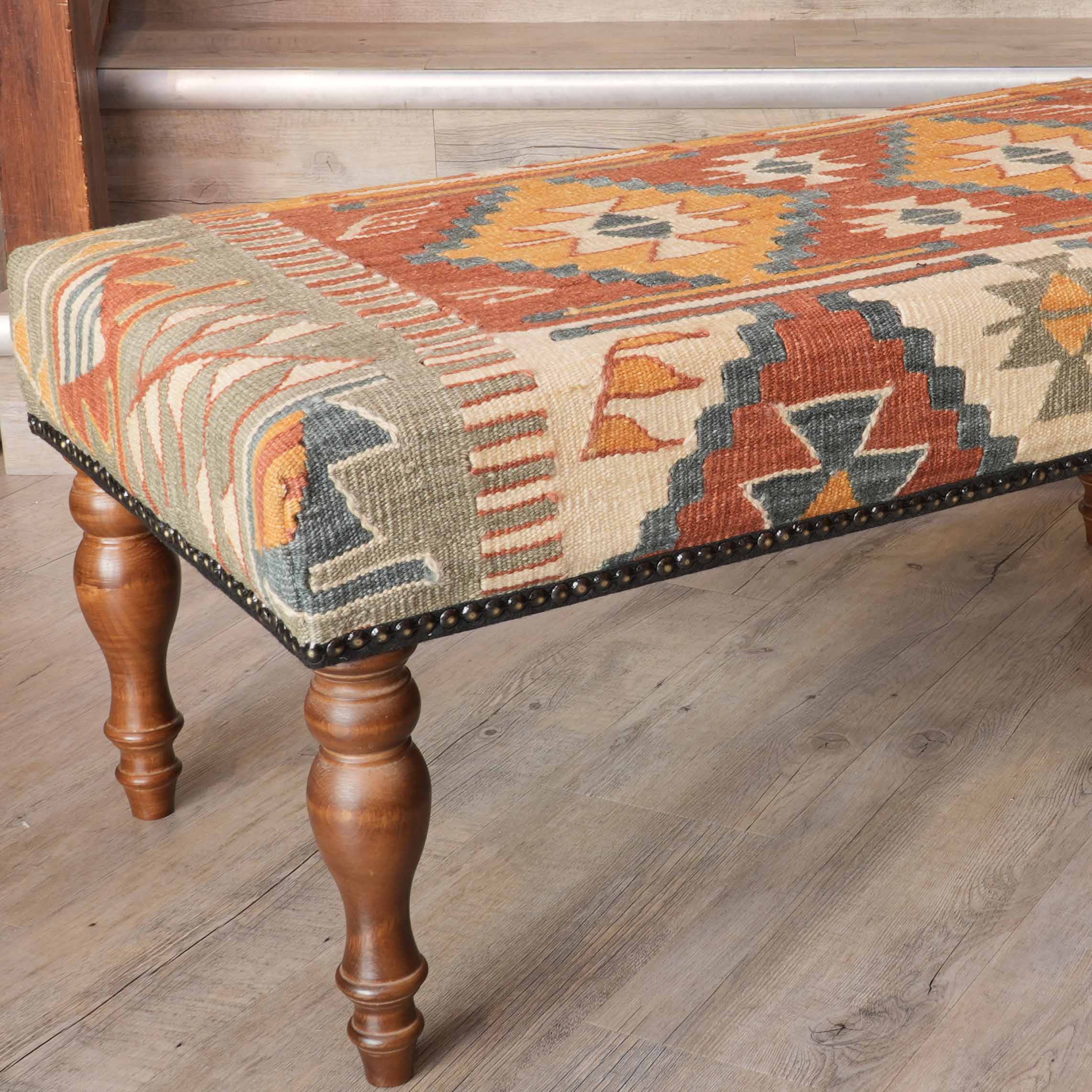 Turkish kilim covered foot stool in soft terracotta apricot and blue